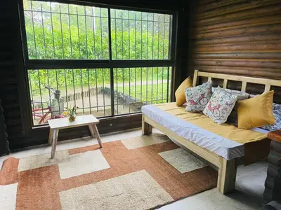 a living room with a couch and a large window at Chalet Palo DAgua in Turbaco