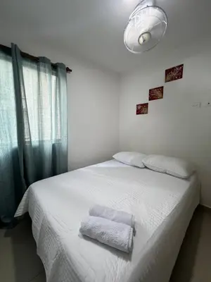 a bedroom with a white bed with two towels on it at Exclusivo apartamento art zona norte in Cartagena de Indias