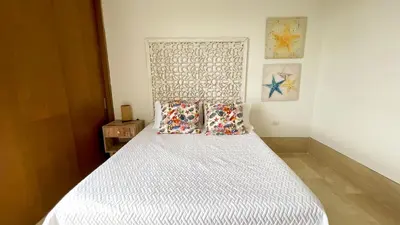 a bed with two pillows on it in a room at Magico Apartamento Frente al Mar 3 Habitaciones TR52 in Coveñitas