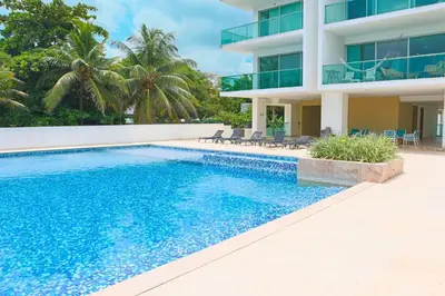 a swimming pool in front of a building at Magico Apartamento Frente al Mar 3 Habitaciones TR52 in Coveñitas
