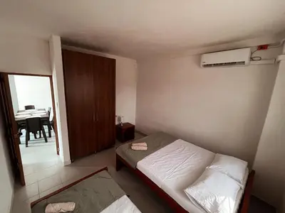 a small bedroom with a bed and a dining room at Madili del Mar II in Santiago