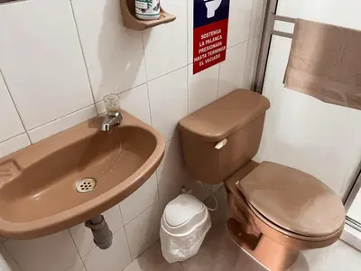 a bathroom with a toilet and a sink at Madili del Mar II in Santiago