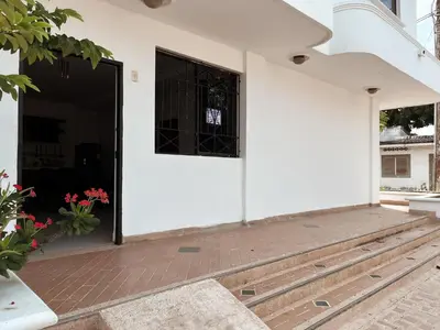 an open door of a white building with a window at Madili del Mar II in Santiago