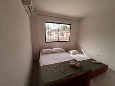 a small bedroom with a bed and a window at Madili del Mar II in Santiago