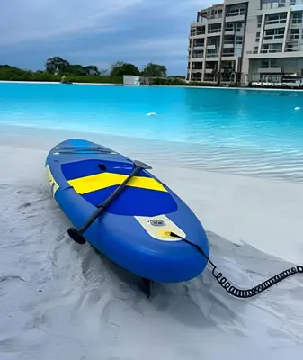 a blue and yellow boat on the sand on a beach at 1 Alcoba Hermosa vista a la laguna + bote inflable in Los Arrayanes