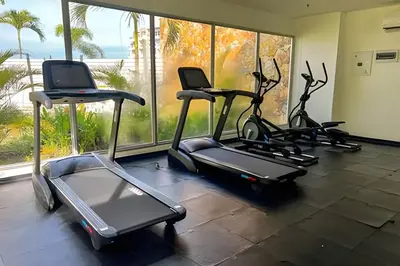 a gym with three exercise bikes in front of a window at 1 Alcoba Hermosa vista a la laguna + bote inflable in Los Arrayanes