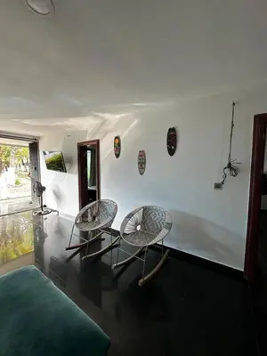 two chairs and a couch in a room at Hermosa Cabaña C15, Castillo Club in Coveñas