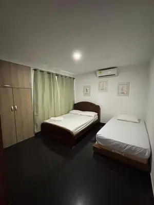 a room with two beds and a cabinet at Hermosa Cabaña C15, Castillo Club in Coveñas