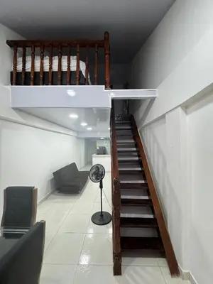 a room with a staircase with a fan and a chair at Edificio frente a la playa en cartagena, marbella in Cartagena de Indias