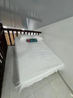 a small bed with a white sheet on it at Edificio frente a la playa en cartagena, marbella in Cartagena de Indias