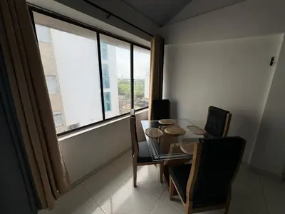 a dining room with a table and a large window at Edificio frente a la playa en cartagena, marbella in Cartagena de Indias