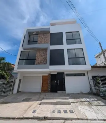 a white house with a lot of windows at Torices casa hostal 47 in Cartagena de Indias