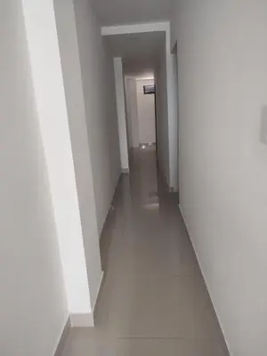 an empty hallway with white walls and white floors at Torices casa hostal 47 in Cartagena de Indias