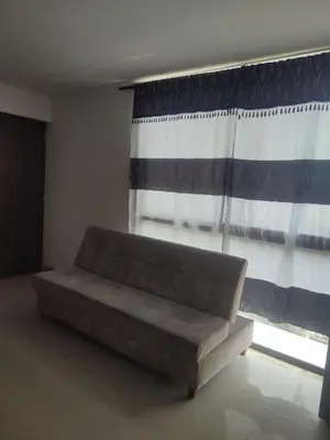 a couch sitting in a room with a window at Torices casa hostal 47 in Cartagena de Indias