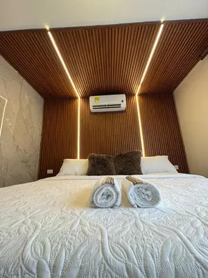 a bedroom with a large bed with two towels on it at Hospedaje de lujo baru in Playa Blanca