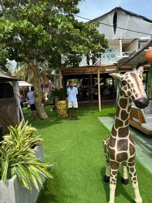 a statue of a giraffe sitting on the grass at Habitaciones luxury baru in Playa Blanca