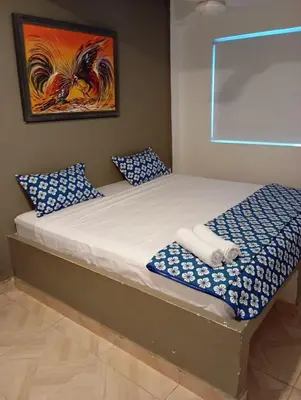 a bed with blue and white pillows in a room at Hotel Nativo Manzanillo in Cartagena de Indias