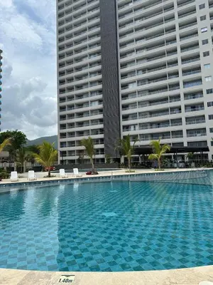 a large swimming pool in front of a large building at Apartamento de lujo en Santa Marina Santa Marta in Santa Marta