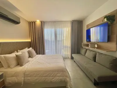 a hotel room with a bed and a couch at Apartamento de lujo en Santa Marina Santa Marta in Santa Marta