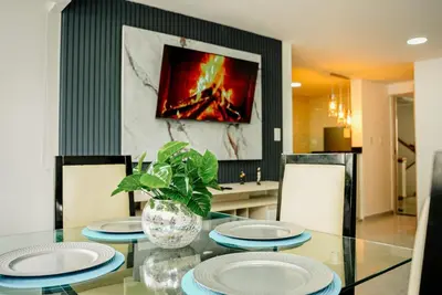 a dining room with a glass table with plates on it at Apartamento Laguito Cartagena in Cartagena de Indias
