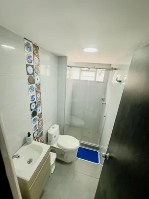 a bathroom with a toilet and a sink and a shower at Apartamento Laguito Cartagena in Cartagena de Indias