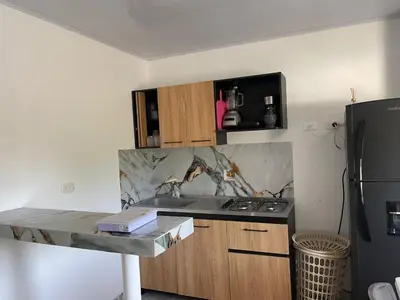 a kitchen with a counter and a sink and a refrigerator at Apartamento M&M in Coveñas