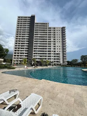 a large building with a swimming pool in front of a building at Elemnt Rentals in Santa Marta