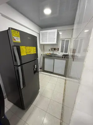 a kitchen with a black refrigerator in a room at Hermoso estudio en Cartagena edificio frente al mar in Cartagena de Indias
