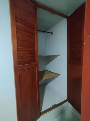 a closet with a wooden door and shelves at Casa Turistica Parador Verona in Cartagena de Indias