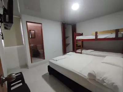 a bedroom with a bed and two bunk beds at Casa Turistica Parador Verona in Cartagena de Indias