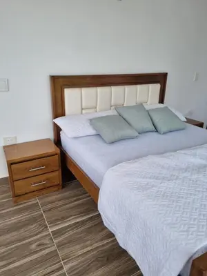 a bedroom with a bed with two pillows on it at HELENA Beach House in La Rada