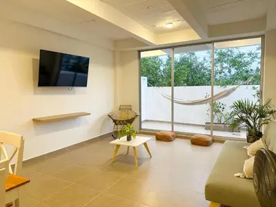 a living room with a couch and a tv on a wall at Apartment for 4 Guests in Sabanilla a few steps from the sea in Maizal
