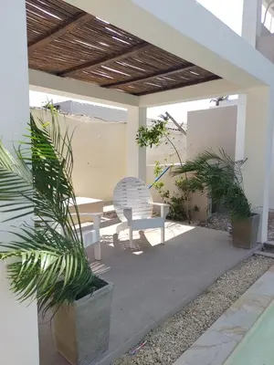 a patio with a white chair and a table at Apartment for 4 Guests in Sabanilla a few steps from the sea in Maizal
