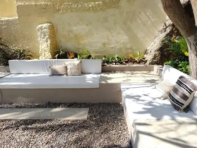 a white bench with two pillows on it at Apartment for 8 Guests in Sabanilla a few steps from the Sea in Maizal