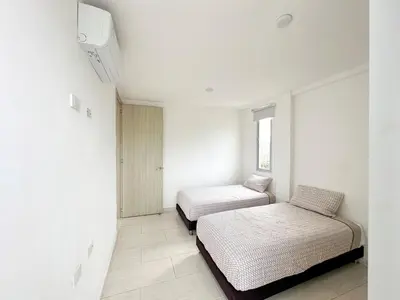 a white room with two beds and a window at Apartment for 8 Guests in Sabanilla a few steps from the Sea in Maizal