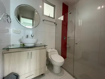 a bathroom with a toilet and a sink and a mirror at Apartamentos Mi Reserva OK - Arrecife in Coveñas