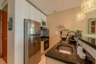 a kitchen with a stainless steel refrigerator and a sink at Apartamento con vista al mar - Piscina en la azotea - 2 habitaciones + 2 baños in Cartagena de Indias