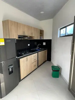 a kitchen with wooden cabinets and a sink at Apartamento Salome in Coveñitas