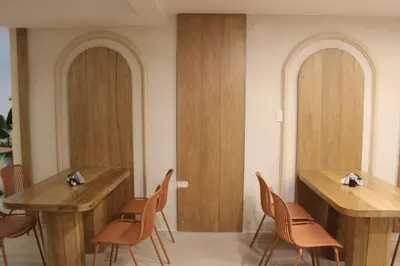 a restaurant with wooden tables and chairs in a room at Hotel Fontamar 72 in Barranquilla