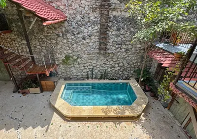an outdoor swimming pool in front of a building at Casa del Tunel Lodge in Getsemani in Cartagena de Indias