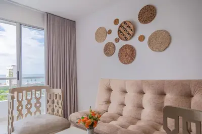 a living room with a couch and a large window at Cartagena Económica con Estilo y Comodidad in Cartagena de Indias