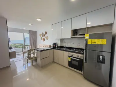 a kitchen with stainless steel appliances and a large window at Cartagena Económica con Estilo y Comodidad in Cartagena de Indias