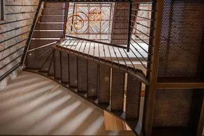 a spiral staircase in a building with a stained glass window at Hotel Casa Sonara in Cartagena de Indias
