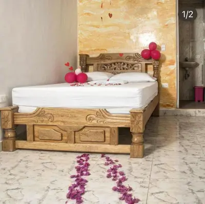 a bedroom with a wooden bed with balloons on it at eco hotel lili in Isla Fuerte