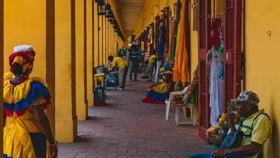 a group of people sitting down on a street at Apartment near the beach and airport in Cartagena de Indias