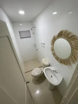 a bathroom with a toilet and a sink and a mirror at Apartment near the beach and airport in Cartagena de Indias