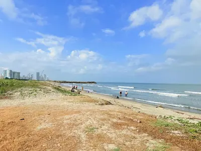 a group of people on a beach near the ocean at Amazing loft - 2 minutes from the airport! in Cartagena de Indias