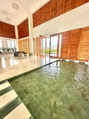 a large pool of water in a large room at Hermoso apartamento serena del mar #1 in Puerto Tierrabaja