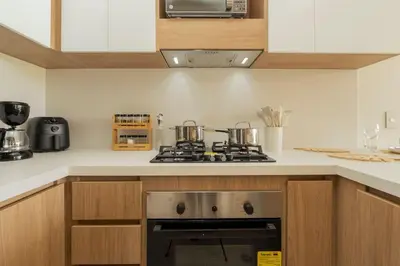 a kitchen with a stove with two pots on it at BK2L | Escápate a Baía Kristal, sol + arena blanca in Los Arrayanes