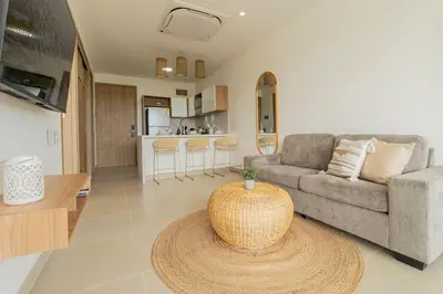 a living room with a couch and a table at BK2L | Escápate a Baía Kristal, sol + arena blanca in Los Arrayanes